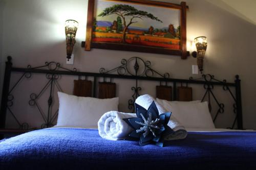 a bedroom with a bed with a blue flower on it at Jarina Guesthouse in Wolmaranstad
