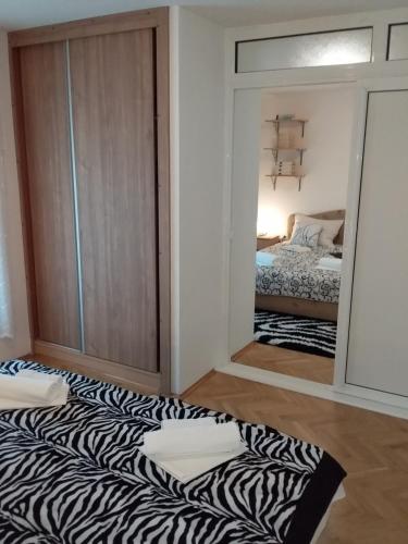 a room with a zebra patterned rug on the floor at Apartmani Steni in Sveti Stefan