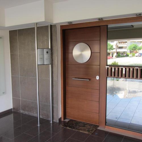 a wooden door in a room with a window at Deluxe boutique suite , jacuzzi, private parking, fireplace in Thessaloniki