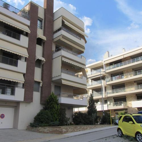 an apartment building with a car parked in front of it at Deluxe boutique suite , jacuzzi, private parking, fireplace in Thessaloniki