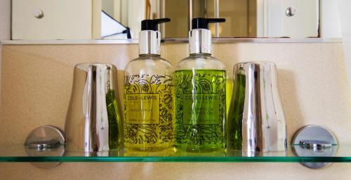 a shelf with two green bottles on it at Rye Hill Farm in Hexham