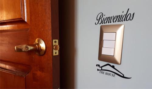 a door with a sign that reads at The House in Tacna