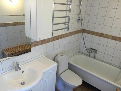 a bathroom with a sink and a toilet and a tub at Family villa near sea and Stockholm city in Stockholm