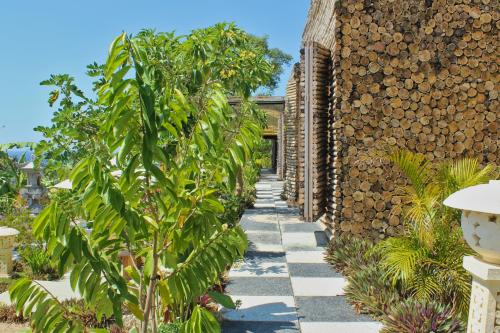 a garden with plants and a stone walkway at Kabeh Jati Garden Villa & Restaurant in Nusa Penida