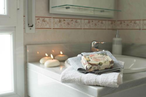 a bathroom with candles and towels on a counter at Cozy Apartment Banus in Marbella