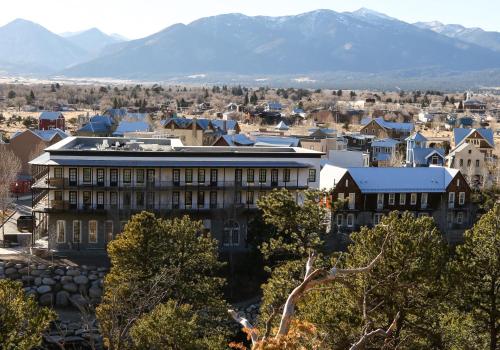 a city with a building and mountains in the background at Surf Hotel & Chateau in Buena Vista