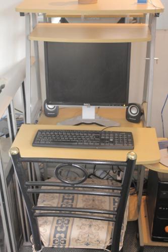 a computer monitor sitting on a desk with a keyboard at Hostal Alfredo's Palace in Cusco