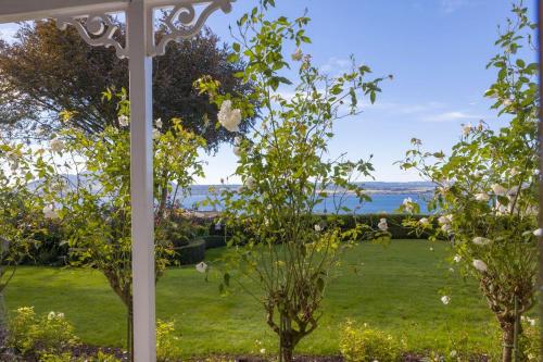 a view of a garden from the porch of a house at Bellevue Boutique Lodge in Taupo