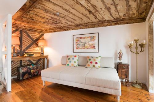 リスボンにあるCharming Apartment Travessa do Alcaideの木製の天井の客室のベッド1台分です。