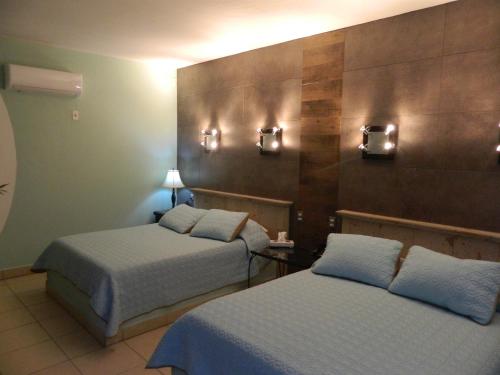 Una cama o camas en una habitación de Hotel Condominium La Posada de Bucerias