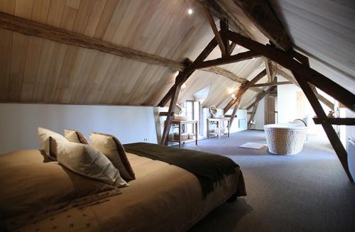 a bedroom with a large bed in a tent at Domaine de la Fouardière in Mulsans