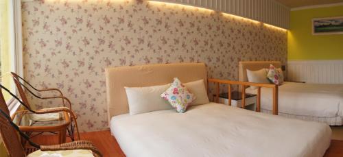 Postel nebo postele na pokoji v ubytování 南灣飯店 Kenting Nanwan Hotel