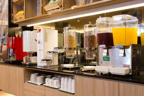 a kitchen with a counter with a bunch of equipment at V-Hotel in Taitung City