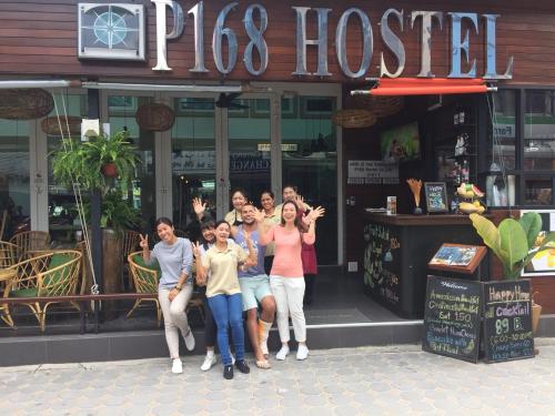 a group of people posing in front of a pizza house at P168 Hostel Samui in Chaweng