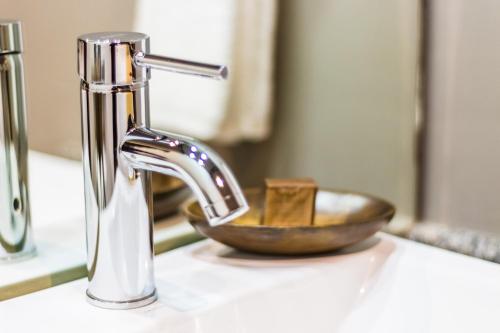 a sink with a faucet and a bowl on a counter at KABAH Cancun Hotel Boutique in Cancún