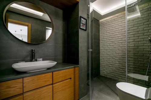 a bathroom with a sink and a mirror at Apartments Magic Sea View in Kotor