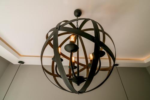 a circular light fixture hanging from a ceiling at Apartments Magic Sea View in Kotor