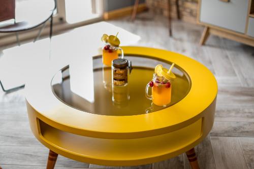 a yellow table with drinks on it in a room at Apartments Magic Sea View in Kotor