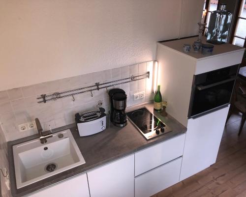 a small kitchen with a sink and a stove at Ferienwohnung Nägler in Erbach