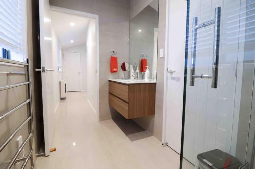 a bathroom with a sink and a shower at Halfmoon Bay Apartment in Auckland