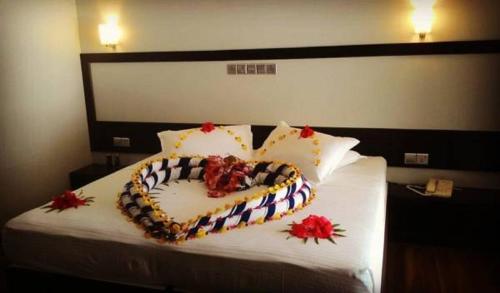 a bed with a cake on top of it at Batuta Maldives Surf View in Thulusdhoo