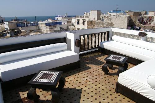 a balcony with two benches and a view of a city at Riad Bab Essaouira in Essaouira