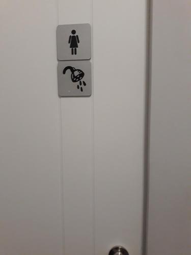 a door with a sign on it with a dog on it at Hostel Sopot Centrum in Sopot