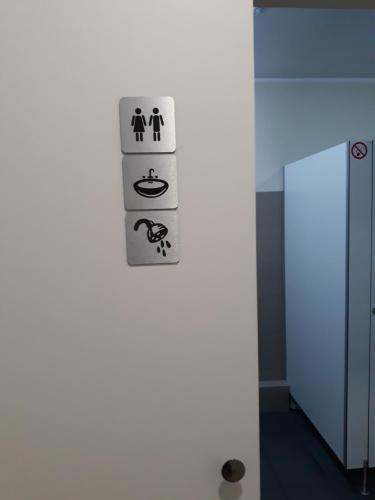 a white wall with a sign on a wall at Hostel Sopot Centrum in Sopot