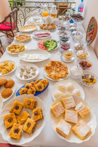a long table with plates of food on it at L'Argamak in Samarkand