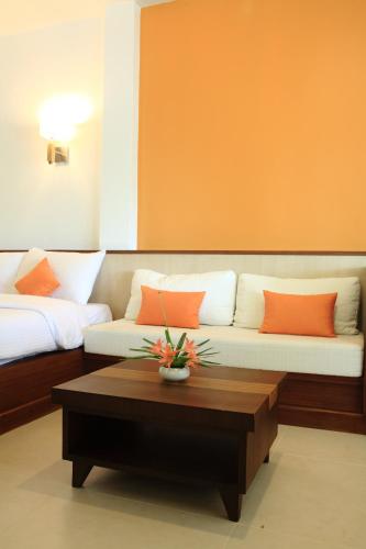 a living room with a couch and a coffee table at Suan Sai Yok Resort in Sai Yok