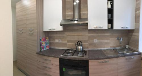 een keuken met een wastafel en een fornuis top oven bij Appartamento Duca in Trento