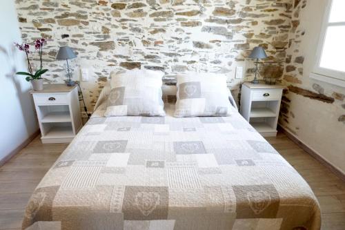 a bedroom with a large bed with two night stands at La Bergerie De Valerie in Arthès