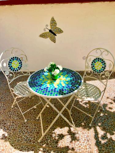 a table and two chairs with a butterfly on the wall at Luxury Villa Minerva Gardens in Split