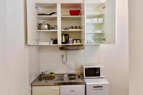 a small kitchen with a sink and a microwave at Luxury Villa Minerva Gardens in Split