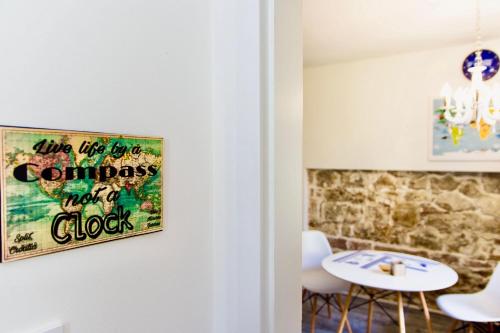 a room with a table and a sign on the wall at Luxury Villa Minerva Gardens in Split