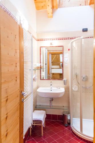 a bathroom with a sink and a shower at Agriturismo Pianrestel in Cavalese