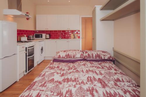 a small kitchen with a bed in the middle of it at Firhurst in Aboyne