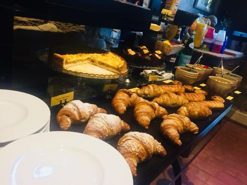 a display of croissants and other pastries on a table at Borgo Cadonega in Viano