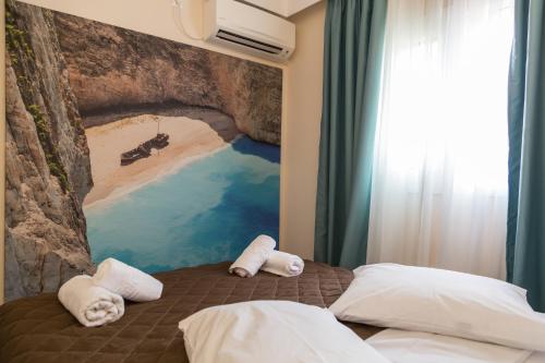 a bedroom with a painting on the wall at Laura Beach House in Alykes