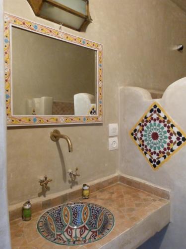 a bathroom with a sink and a mirror at Riad Etoile De Mogador in Essaouira