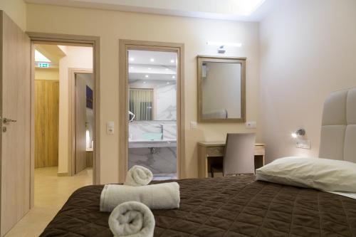 a bedroom with a bed with two towels on it at Laura Beach House in Alykes