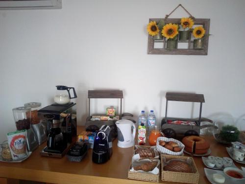 a table with a coffee maker and food on it at Quinta da Corujeira in Vila Real