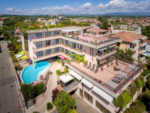 an aerial view of a large building with a swimming pool at Hotel Desenzano in Desenzano del Garda