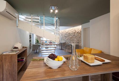 a kitchen with a table with a bowl of fruit on it at B&B La Bellavita del Garda Luxury in San Felice del Benaco