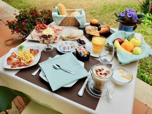 a table with breakfast foods and drinks on it at Tiliguerta Glamping&Camping Village in Costa Rei