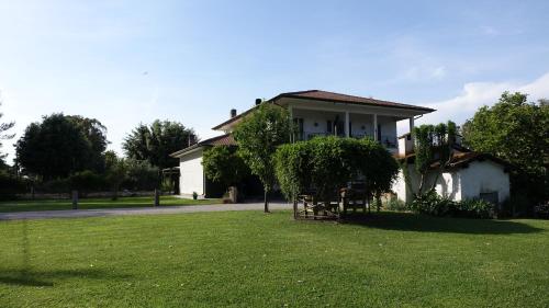a house with a green lawn in front of it at Casa Vacanze Feudi 1165 in Borgo Vodice