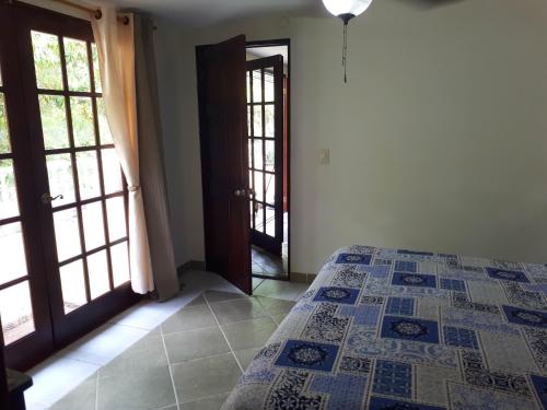 a bedroom with a bed and an open door at Hibiscus House Bed and Breakfast in Contadora