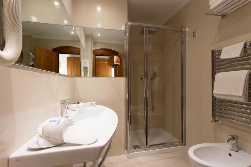 a bathroom with a sink and a shower at Hotel Imperiale in Milano Marittima