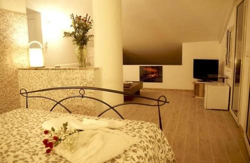 a bedroom with a bed and a living room at La Porta dell'Alcantara in Gaggi