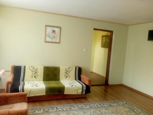 a living room with a couch and a rug at Садиба у Брусків in Mizhhirʼʼya